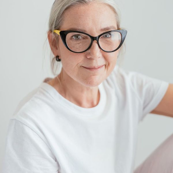 Person stretching gracefully in a bright, minimalist room.